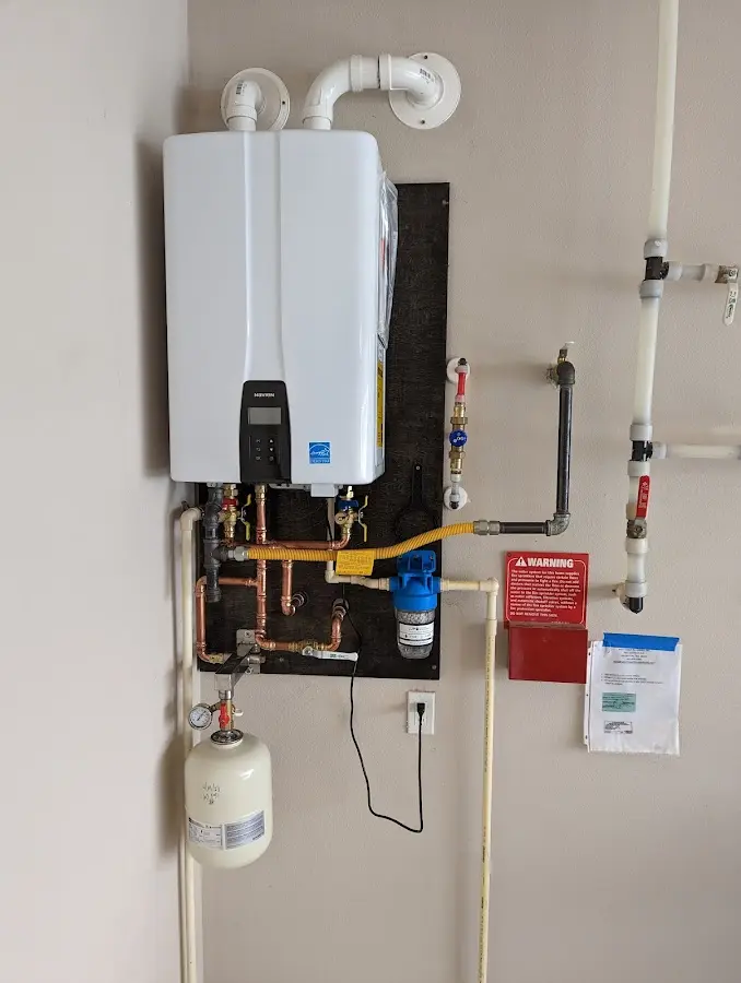 Professional plumber installing copper piping in a Matthews home